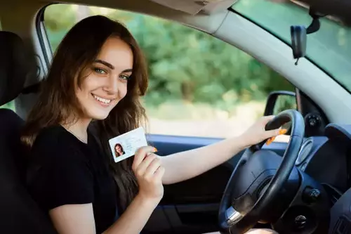 cute girl holding fake driver license USA